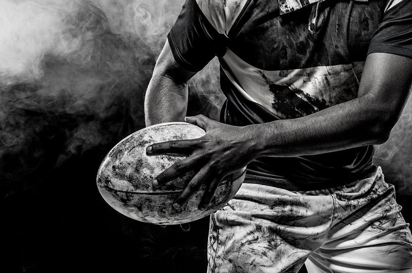 Dynamic rugby player graphic symbolizing the intense energy of 6 Nations at The Railway East Grinstead.